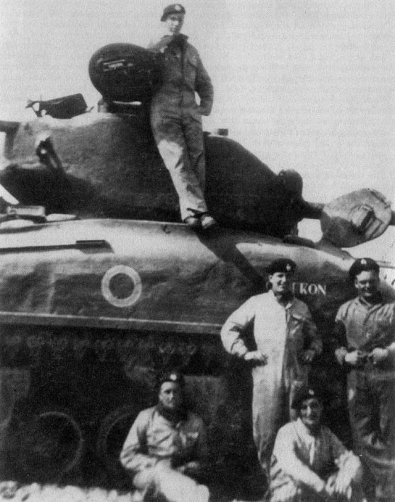 A Sherman Crew of C Squadron 2nd RTR by their US 76mm tank in Italy 1944. The name of the tank is 'CAMERON'.
