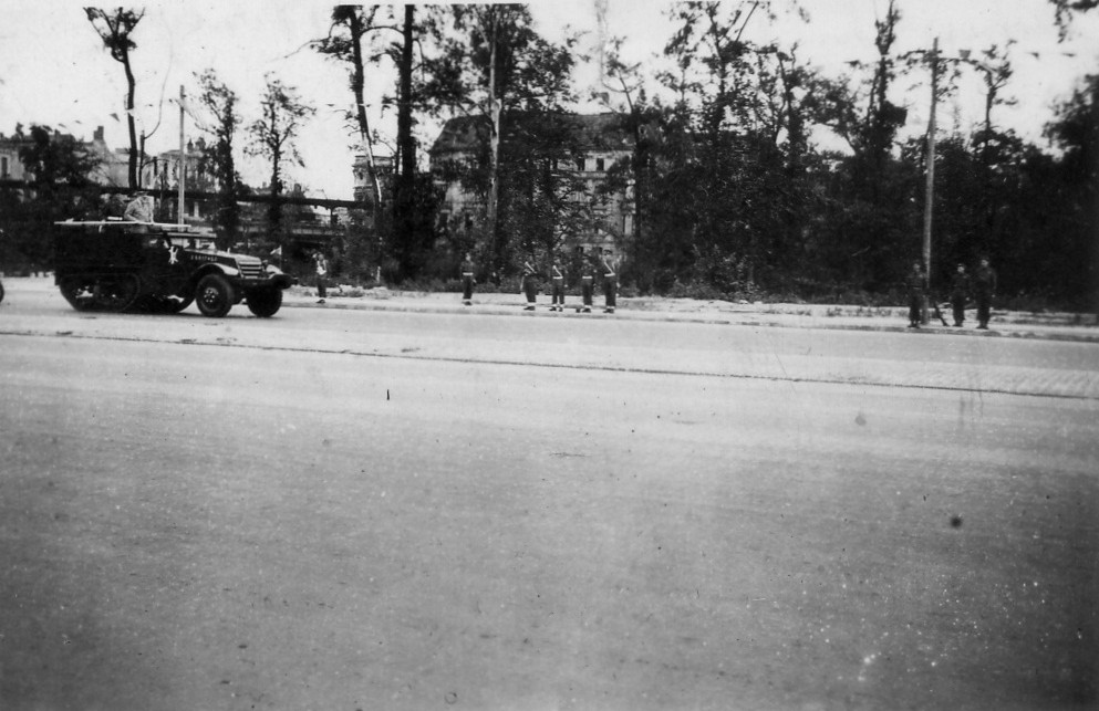 A Half-Track carrying what looks like Winston Churchill.