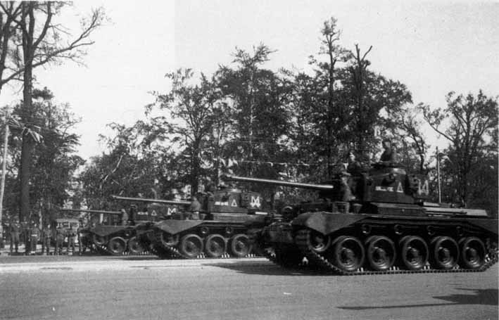 Comet Tanks of A Squadron, 1st RTR, saluting during the parade.