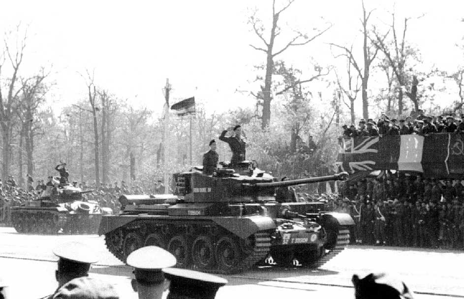 Comet Tank, with Chaffee behind it saluting during the parade. Tanks of the Desert Rats, they were the only ones to actually salute as they went past. The other nation's tank crews either turned their turrets or made no display. The 52 TAC sign denote it as 1st RTR. Photographer Reg Pidsley Copyright © Rob Clayton