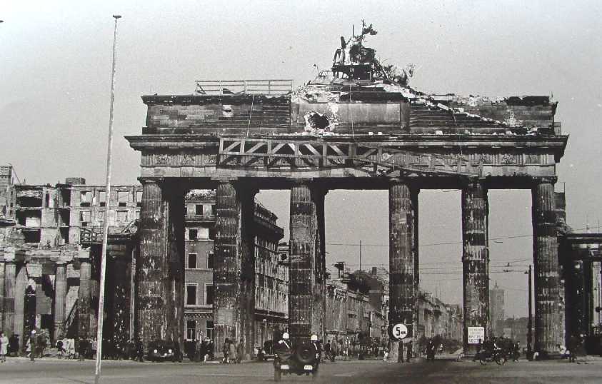 Into the heart of the Nazi capital -Brandenburg Gate taken from the reverse side. side of the gate that was the edge of the British sector. The jeep contains US military police. Photographer Reg Pidsley Copyright © Rob Clayton